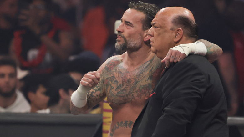 CM Punk puts his arm around Paul Heyman