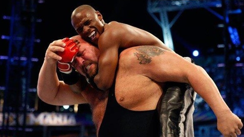 World famous boxer Floyd Mayweather Jr. climbs on top of Big Show's (Paul Wight's) back during their WrestleMania 24 match