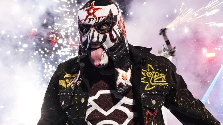 Penta poses on the ramp, his pyro going behind him, during his entrance before a match on 