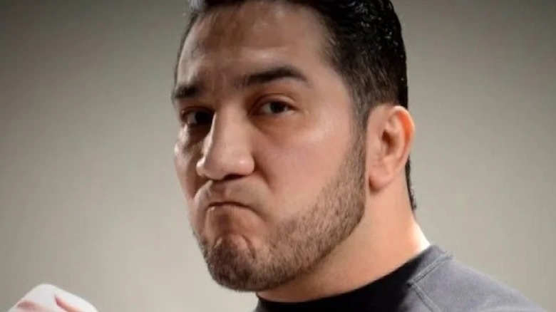 Perro Aguayo Jr. clenches his fist.