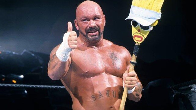 Perry Saturn in ring with 'Moppy' during a 