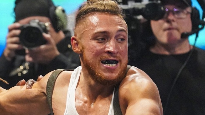 Pete Dunne as "Butch" in a match