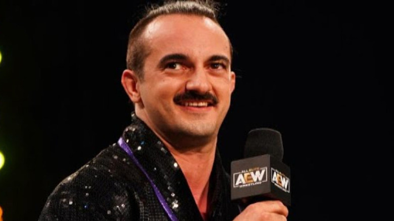 Peter Avalon smiles microphone AEW