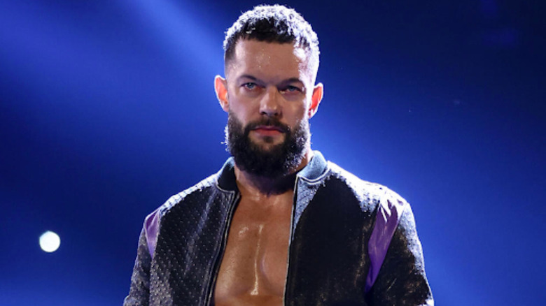 Finn Balor sitting on turnbuckle