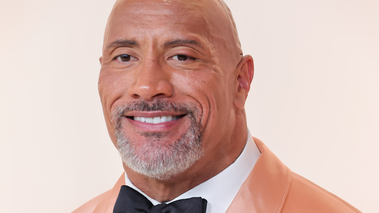 Dwayne "The Rock" Johnson smiles at how good his David Beckham costume will look