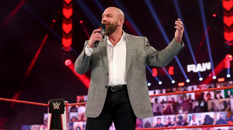 Joel Embiid Walks Out with Triple H to Ring The Bell 