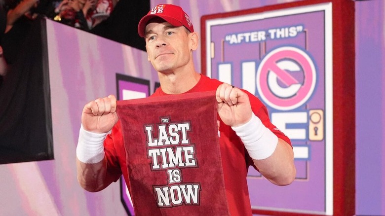 John Cena poses with his "The Last Time Is Now" towel
