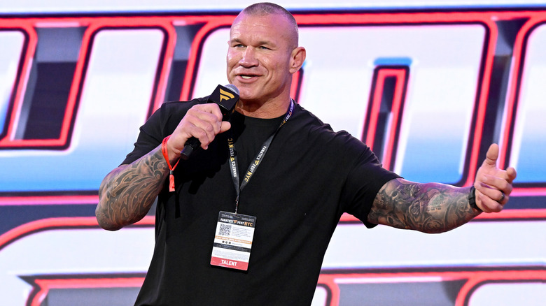 Randy Orton talking into a microphone at an event