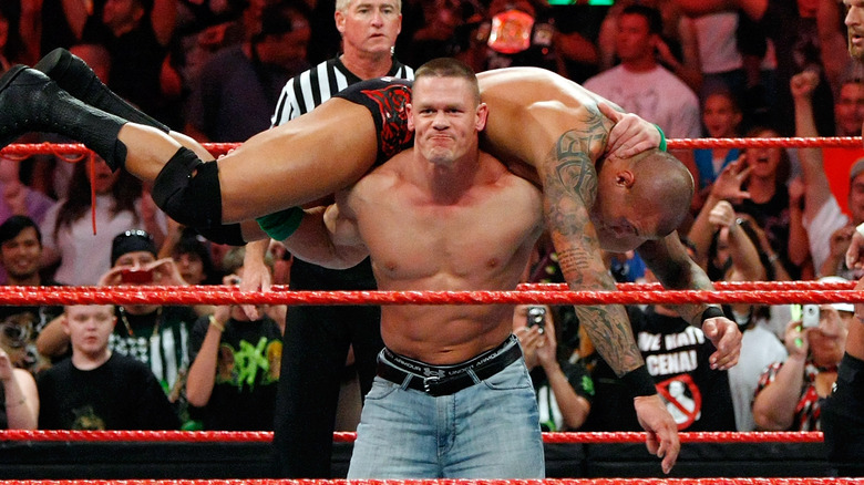 John Cena makes a weird face while holding Randy Orton up for an Attitude Adjustment