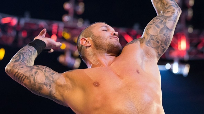 Randy Orton hits his signature pose in the turnbuckle of the ring before a match.