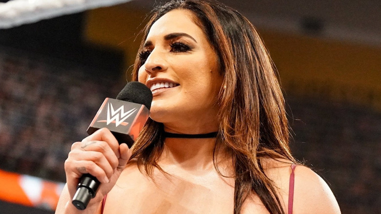 Raquel Rodriguez talking into a microphone