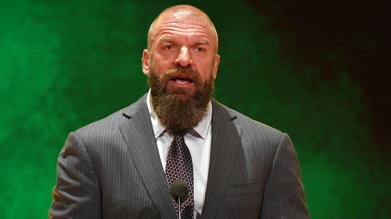Triple H awaits a question from press during a media scrum