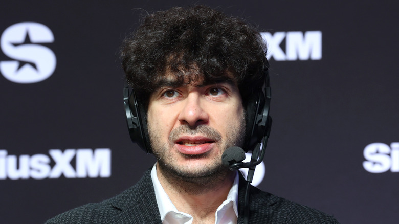 Tony Khan wearing a headset while on radio