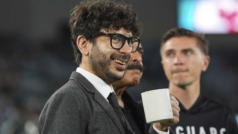 Tony Khan with a coffee mug