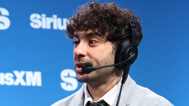 Tony Khan talking with a headset on