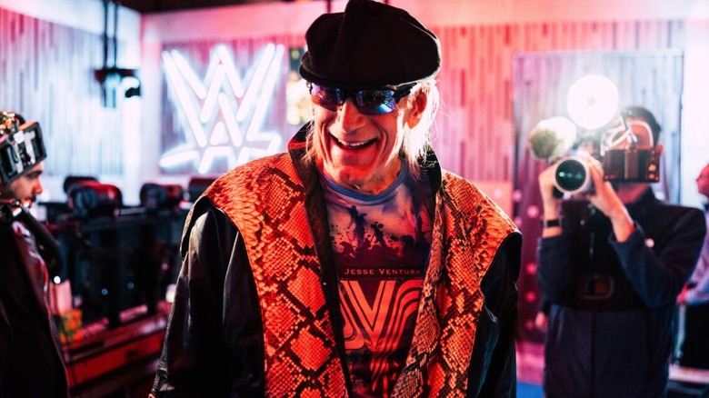 Jesse Ventura smiles for the cameras filming him backstage in gorilla at WWE's revived Saturday Night's Main Event.