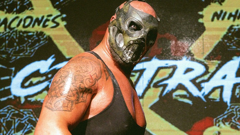 Major League Wrestling's Mads Krule Krügger (also known as Krule) poses in front of the CONTRA Unit banner