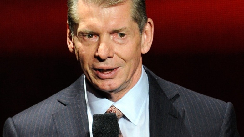 Vince McMahon holding a mic