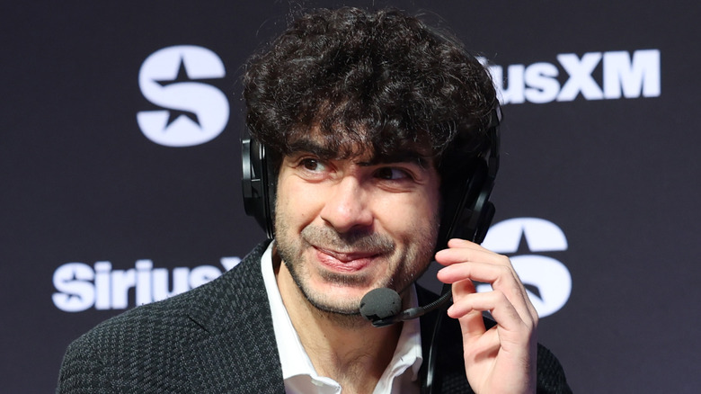 Tony Khan fixes his headphones