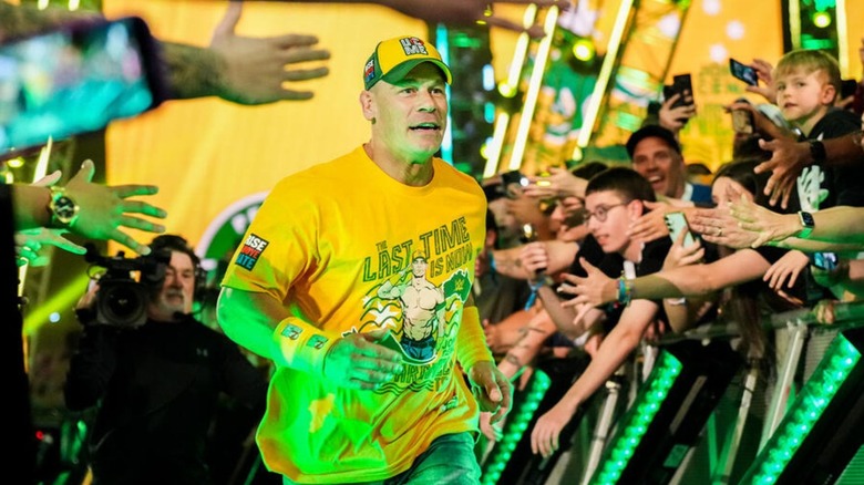 John Cena heads down to the ring with fans reaching to him across the ring barricades before his match against AJ Styles at Crown Jewel.