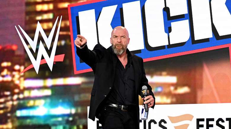 Triple H pointing at Danhausen's merch sales
