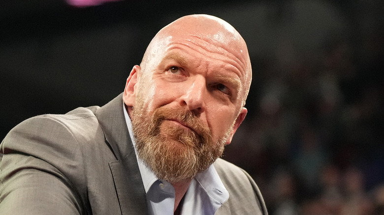Triple H leaning on the ropes