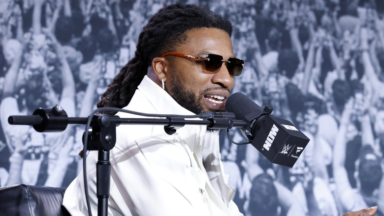 Trick Williams talking into a microphone