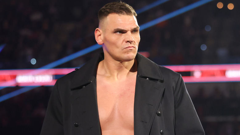 GUNTHER wearing a long, black coat