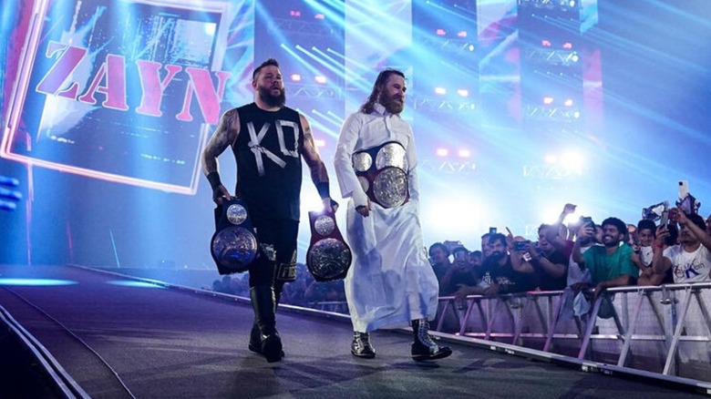 Sami Zayn and Kevin Owens walk down the ramp to the ring before their match for the tag team championships against Solo Sikoa and Roman Reigns at Night of Champions.