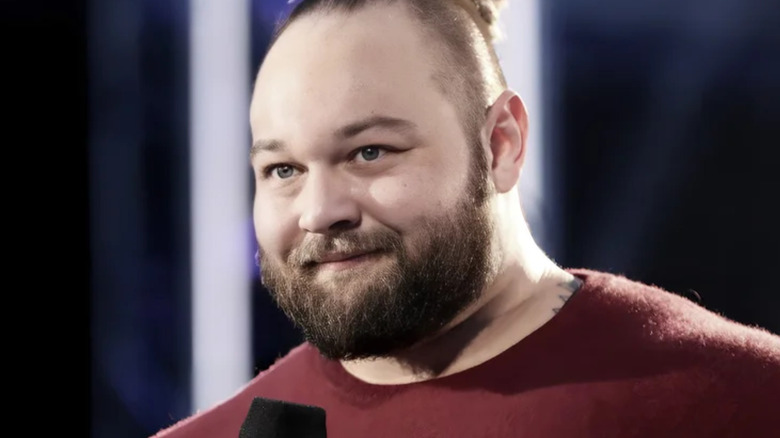 Bray Wyatt holding a microphone