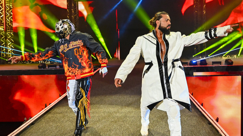 Rey Fenix and Andrade enter the arena during SmackDown at Kingdom Arena on June 27, 2025 in Riyadh, Saudi Arabia.