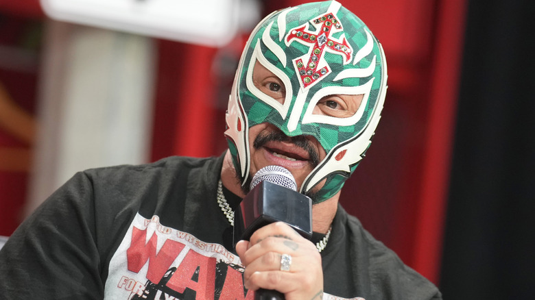 Hall of Famer Rey Mysterio answers a question during a press event