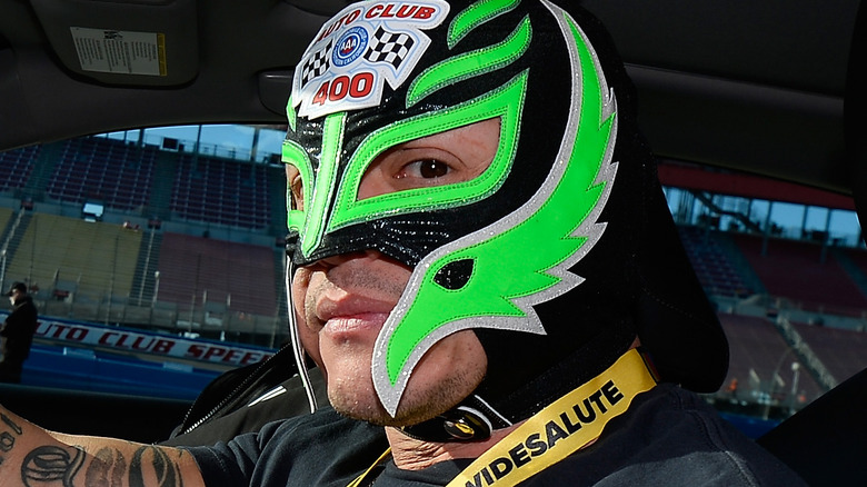 Rey Mysterio in driver's seat of stock car