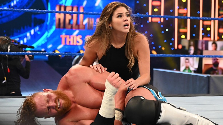 Aalyah Mysterio cradling Murphy (Buddy Matthews) on an episode of 