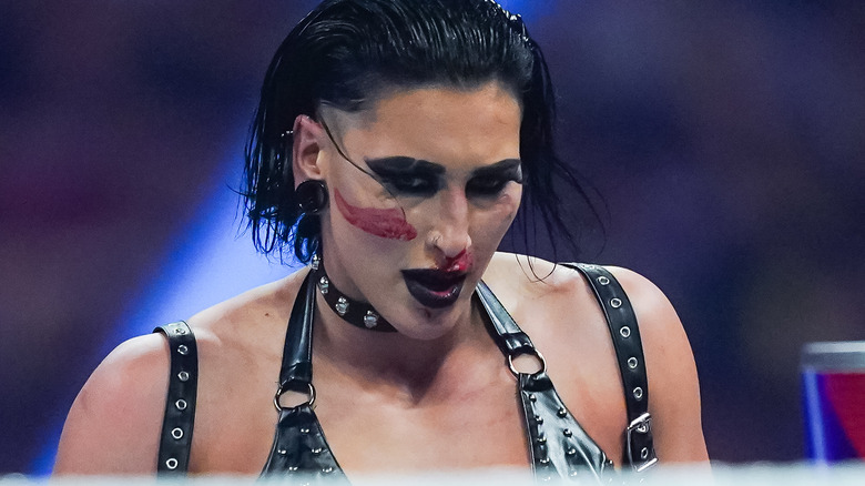 Rhea Ripley looking down at her opponent