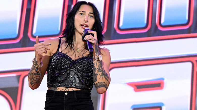 Rhea Ripley talking into a microphone at an event