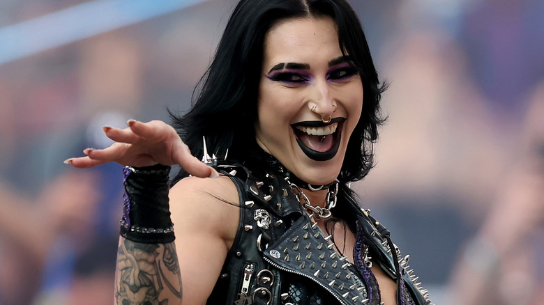 Rhea Ripley offers a teasing wave and grin as she makes her entrance.