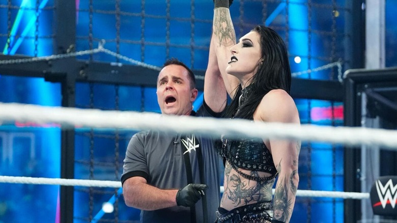 A referee raises Rhea Ripley's hand in victory after she won the 2026 Elimination Chamber match.