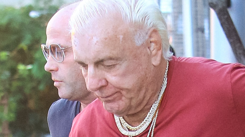 Ric Flair looks down at ground