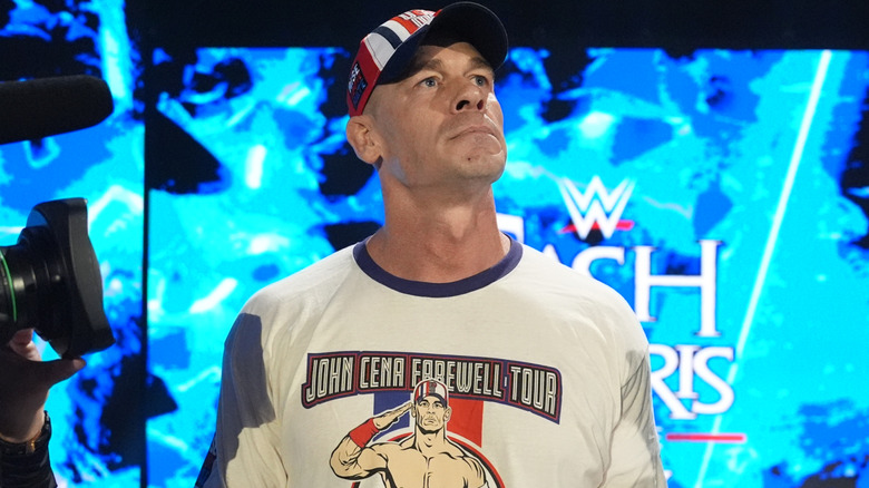 John Cena is wearing a white t-shirt