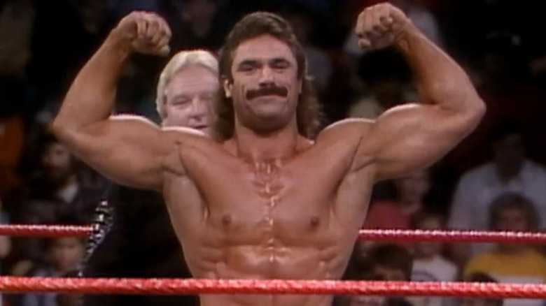 Rick Rude flexes in the ring