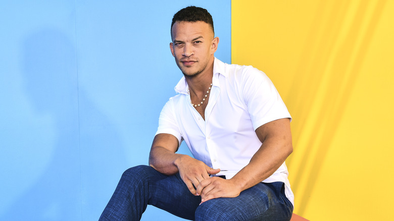 Ricky Starks raises his eyebrow in a colorful room