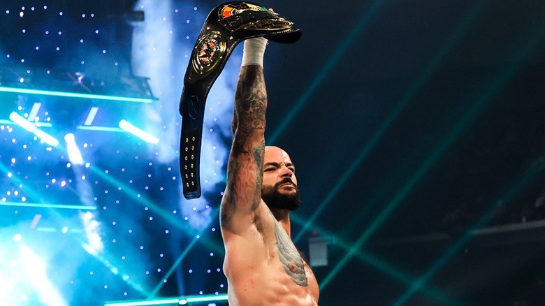 Ricochet posing with Speed title