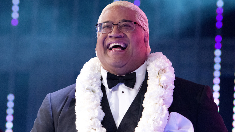 Rikishi is smiling and wearing glasses