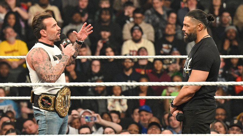 CM Punk and Roman Reigns talking in the ring