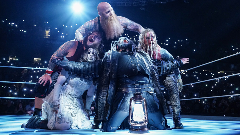 The Wyatt Sicks posing together in the ring near a lantern