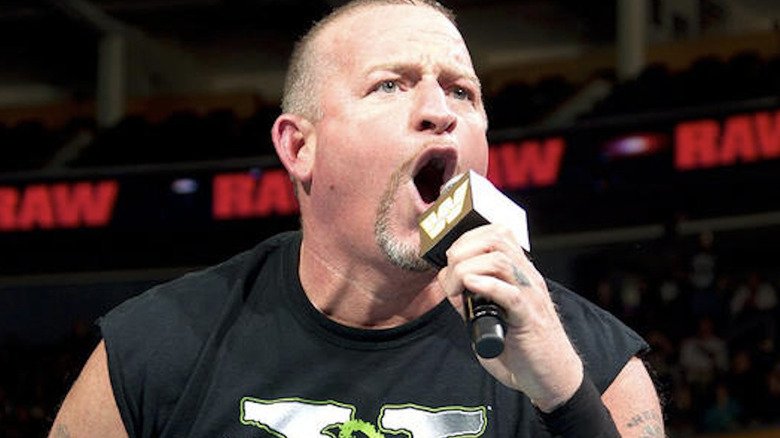 Road Dogg talking into WWE microphone 