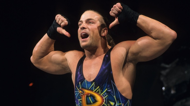 Rob Van Dam pointing his thumbs at himself as a young man
