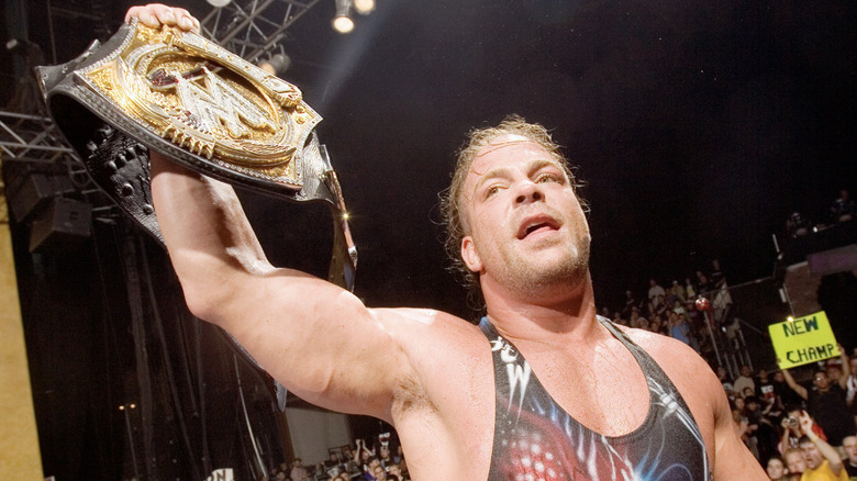 Rob Van Dam holding up his title