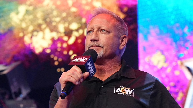 Jerry Lynn holding an AEW microphone